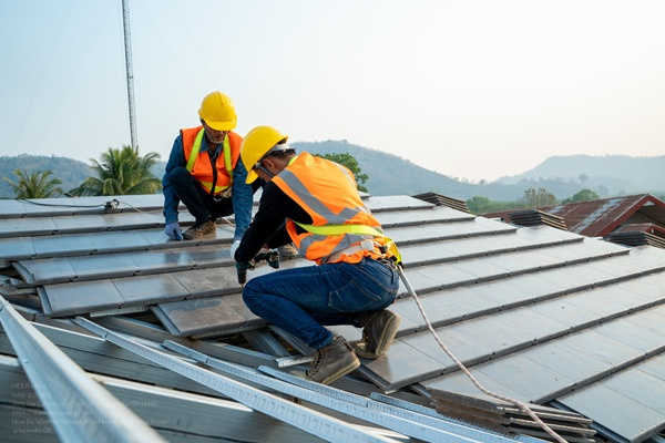 Roofer Builder Worker Installing Ceramic Roof On Top Of The New