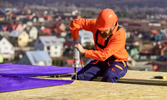 Materials Requirements. Install Partially Overlapping Layers Of Material Over Roof Insulation Surfaces. Master Repair Roof. Flat Roof Installation. Roofer Constructing Roof. Man Roofing Surface