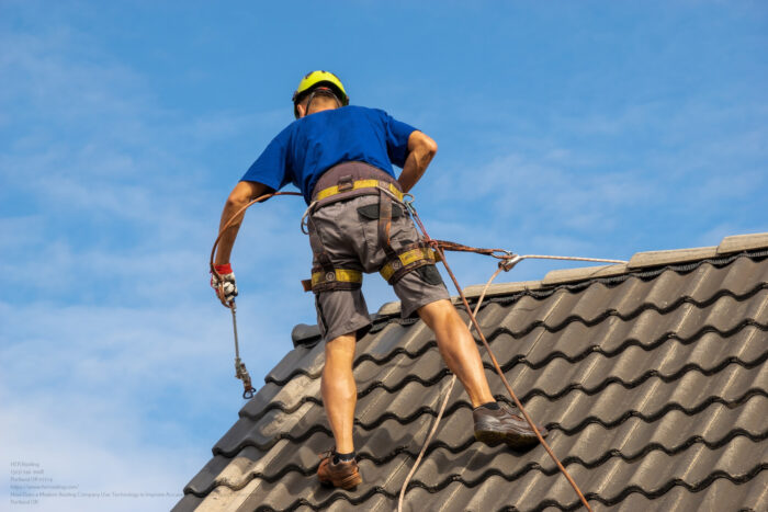 High Altitude Worker Painting A Roof